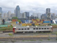 CN's test RDC is something I had been trying to shoot for years, but the timing had never worked out. This past Friday I was finally able to shoot it leaving Pointe St-Charles Yard in the morning, on its way to testing the Montreal Sub (the slightly elevated tracks in the background). Behind the Montreal Sub are some MGLX cars at Ray-Mont Logistics. Behind that is the skyline of downtown Montreal, one railway-related building is the Marriott Château Champlain hotel at left, built by CP across the street from its then headquarters of Windsor Station and opened to the public in 1967.