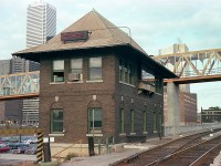 I wonder how many realize this structure still exists?  John St tower, at the foot of John St down by the railroad corridor was built around the same time the 'new' Union Station came into being, back in the 1920s. From this building track was controlled between Union and Bathurst Yard.
The Tower still exists, looking a lot less like a tower, since its roof was shaved off in order to accommodate the walkway over the railroad to the Rogers Centre. So it is now hidden away right below the walkway.
In this photo you can see the first walkway, this to the CN Tower immediately to the east.  Once upon a time John St was a neat little place to catch some passenger traffic.  But that was 40 years ago.................