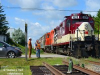 Reversing to work PDI Massey, Engr. Peter Harwick waves to Guelph Junction Railway's Les Petroczi, at the time Guelph Junction Railway's only employee complete with the GJR logo on his van. A siding was recently added at this location to assist in working AOC and PDI on this spur, and at the time, a crossing rehabilitation was planned.