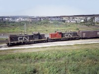 Every time I look at photos like this I rather kick myself for not finding the time to shoot more of them. And now that the GMD-1s are off the roster, it bothers me even more.  This was a nice catch, CN 1905 and 1913, working in Thunder Bay, taken while I was on my way 'out west' in 1976. There no doubt was a lot more to see, but anyone driving across the country knows time is of the essence, and it would be easy to spend a whole day wandering Thunder Bay. So I moved on.
This view is looking west toward the hills of old Port Arthur.