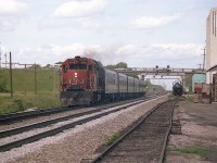 A look eastward by the old Aldershot Cold Storage facility. Far background on the left, beyond the Waterdown Rd overpass is where the current sprawling GO Aldershot station is now located. Close left was location of the long gone Aldershot CN station.  Both sets of signal bridges in photo are gone, as is the siding on the right. The 4016, a GP40, was slated to be renumbered to 9316 in a couple of months, along with the others in the 4002-4017 series..9302-9317......lots of change.......maybe, just maybe..... those old VIA coaches are still around.