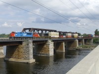 A later than usual CN 185 is leaving the island of Montreal as it approaches Île-Perrot with heritage unit CN 8952 leading and IC 2719 trailing.