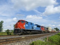 The Grand Trunk heritage unit is leading a late CN 185 as it approaches a crossing at MP 35.74 of the Kingston Sub with CN 8952, IC 2719 and a 448-axle long train.