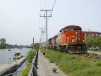 CN 4771 & CN 4808 have just arrived on the East Side Canal Bank Spur with five grain loads for Ardent Mills, at left is the Lachine Canal and in the background is CN's Montreal Sub crossing the canal. Normally this train would arrive from Pointe St-Charles Yard and shove the loads towards the client. In this instance they picked up the cars on track 29 and arrived power first; they are about to run around the cars so they can shove them to the client.