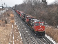 The CN ET44AC big GEs.  I'm tired of them. Even in 2015 it took a bit to get me to rustle myself out into the cold to bother with these. Bitter wind on the Maple Av bridge in Grimsby gave me second thoughts about shooting these new arrivals after already catching them in Merritton. But, what the heck. I persevered. Power is CN 2639, 2501, 5547, 3029, 3028, 3025, 3026 and 3027.