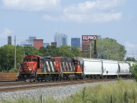 CN 4141 & CN 4707 are heading towards Taschereau Yard with 49 cars. A baretable can be seen at left, part of a CN 599 which will head to the Port of Montreal once numerous trains pass it first.