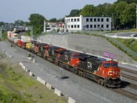 CN 120 has five units (CN 3142, CN 2632, CN 3144, CN 3073 & CN 9555) as it heads east after departing nearby Taschereau Yard.