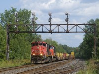 After having to get recrewed before even leaving the Port of Montreal, CN X105 is on its second crew as it passes a classic signal bridge with CN 2514 & CN 5668 for power.