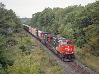 After seeing a bit of commentary below Mr. Host's "freezing cold" but gorgeous image of that plough train at Stratford and the 4001 in consist; I thought I would dig up a photo of when that unit first arrived in Ontario. Just a photo for those who follow the GEXR, here is Lakeland & Waterways #4001 as third unit behind CN 2634 and 2517 on a Toronto-bound manifest train as seen from an overpass just north of Parry Sound.
Lakeland & Waterways was taken over by CN in 2006 after having been a RailLink line since 1997.