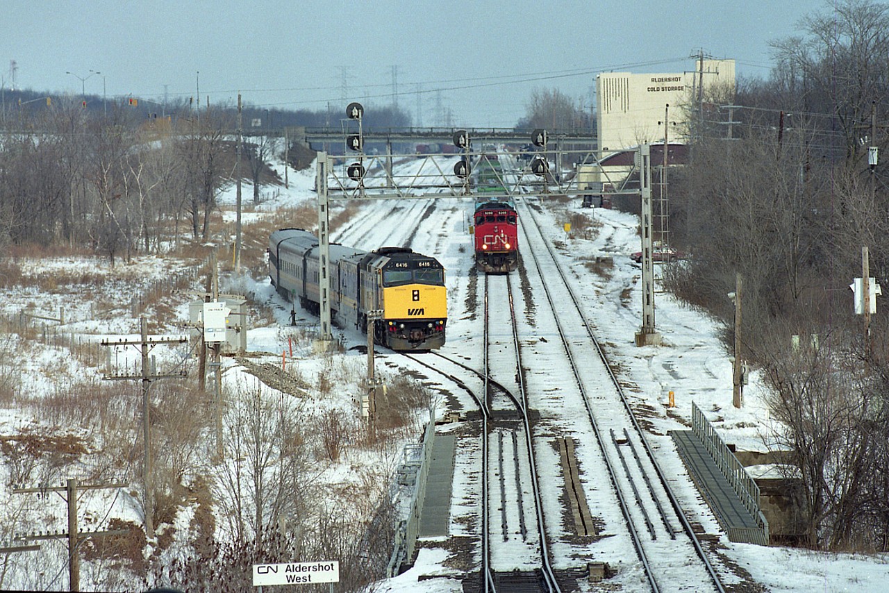 An unusual move by VIA I had not seen before. CN 5260 and 5149 holding with a westbound train, waited for #73 with VIA 6416 to come up the south track (on right) then reverse over two tracks and back into the Aldershot lead as seen here. I shot this as it was in the process of reversing in order to wait for signal. It then got its' light after the crossover at bottom was closed and it headed westbound ahead of the freight.

Must have been maintenance work ahead on the South track.