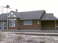 It was a real shame I could not back up any more; choice was fall down the embankment or move to the right and get a bunch of shrubs in the photo.
But you get the idea.  Winona's CN station looked pretty good going into the winter of 1974/75.  However, it did not last to see another. The structure was totally destroyed in a fire around October 1975. A real shame. 
Never heard whether there was a problem within the building or it was arson.  This station was located just off of Winona Rd opposite Railway St., a very short lane in which one could access a siding and a small yard there.
Today, the Costco and its gas bar are opposite where this rather nice building once stood.