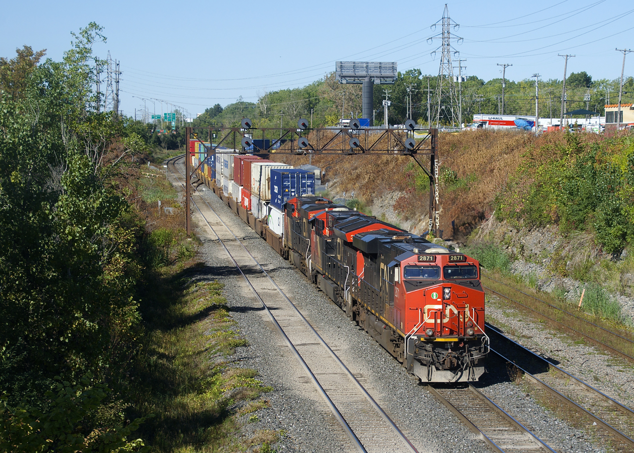 CN 120 is passing under a vintage signal bridge as it exits Taschereau Yard with a trio of GE's up front (CN 2871, CN 3066 & CN 2902).