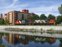 GTW 6262 & CN 4141 are casting a bit of a reflection in the Lachine Canal as they head back to the main line after dropping off six grain cars at Ardent Mills. At far left is the Atwater Market tower. The Atwater Market opened in 1933 and is still a popular location for purchasing fresh foods.