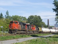 A 154-car CN 527 is about to pass MP 3.13 of CN's Montreal Sub with CN 8017, CN 2570 & CN 8906 for power. The leader is missing part of its nose noodle.