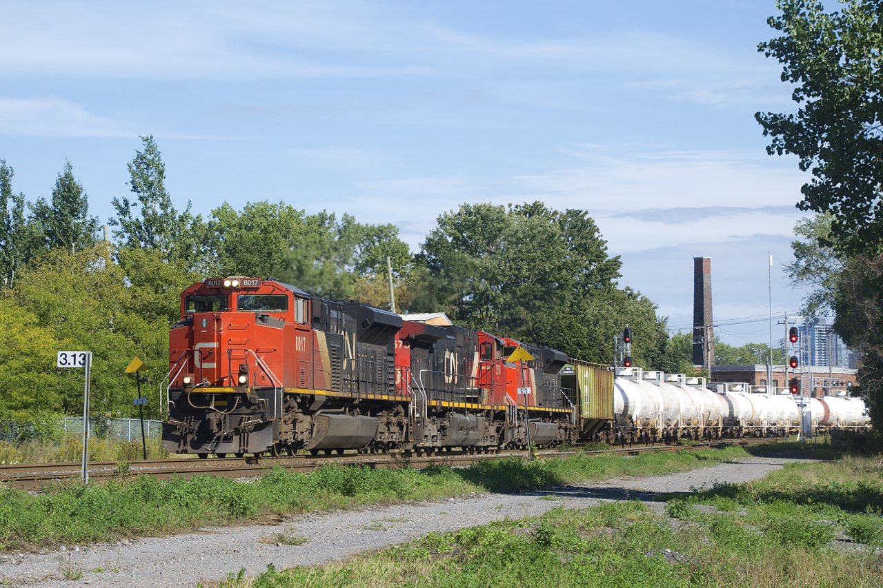 A 154-car CN 527 is about to pass MP 3.13 of CN's Montreal Sub with CN 8017, CN 2570 & CN 8906 for power. The leader is missing part of its nose noodle.