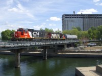 An ex-DTI unit now wearing CN paint (GTW 6226) leads CN 4141 as they enter the Port of Montreal with a transfer.