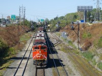 After spending much of the night parked about a half mile west of here, CN 306 is on the move with CN 8845 up front and BCOL 4648 mid-train. Carmen are visible on either side of the train in the distance and they would find a problem with the fourth car. The train would come to a stop a few seconds later and the carmen did some quick work on the problematic car before CN 306 was able to depart about 10 minutes later.