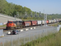 CN 875 is coming to a stop at Turcot Ouest as the outbound crew prepares to get on. A single CN ES44Ac is all the power needed on this 128-car empty grain train.