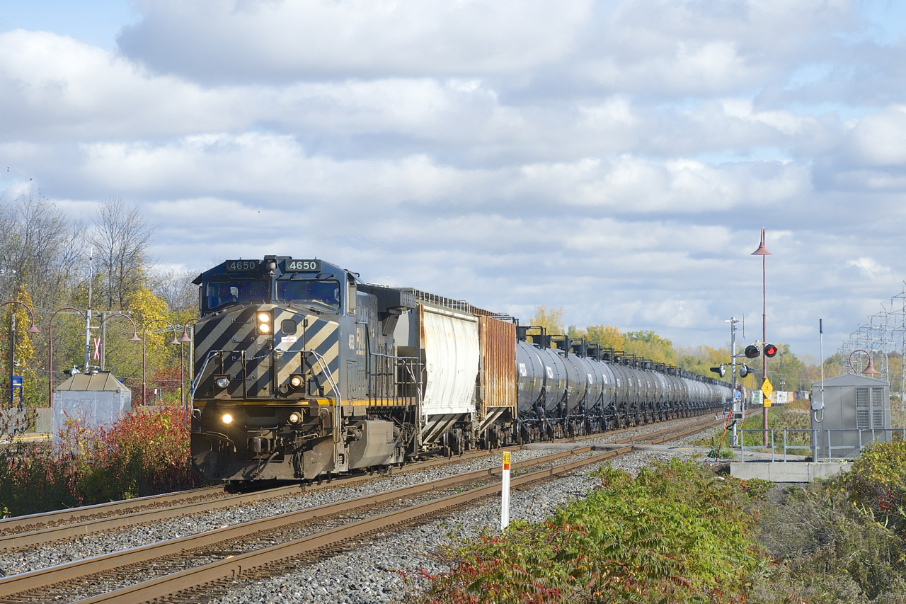 CN 305 has BCOL 4650 up front and CN 2671 mid-train as it heads west.