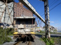 The Pointe St-Charles Switcher's beat-up shoving platform has been left on the CN Wharf Spur as they switch Canada Maltage and Five Roses. The Five Roses facility is visible at left.