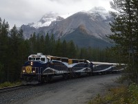 Well, with me; I know a train is coming when the skies turn dark.  Just my luck.  I'm on Lake O'Hara Road; maybe 2 miles west of the Alberta border and a dozen miles east of Field.  I knew the Rocky Mountaineer was on its' way; waited while it navigated the Spiral Tunnel, and was rather disillusioned when the skies turned dark.  Thats the way it goes. RMRX 8011 and 8018 power this eastbound in the late afternoon; destination Banff. The mountains gave this location a nice setting for a photo.