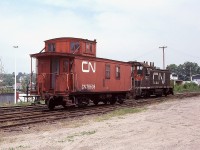 A number of years ago Parry Sound industry was served by a CN local that was stationed along Great Northern Road just the other side of the CP trestle from the large oil tank facilities. When the oil business was gone, so was the CN. The small yard and the equipment you see here have long since departed. This location is right in front of the present day Trestle Brewery and Restaurant in town, south side of the Seguin River between main artery Bowes St and the CP trestle.  CN 1211 was retired in 1993 and the old wooden caboose 78636, built back in the 1912-1920 era; I understand is still in existence. Privately owned and minus its trucks, in Palmerston, ON. Can anyone verify this?