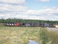 Back in the day when it was relatively easy to wander that big CN yard complex just outside of Moncton, New Brunswick.  This shot is of CN 3632 (RS-18) and CN 1768, 1758 (both RSC-14) about to go around the wye at the west end of the facility.  GPS coordinates are approximate.  Just can't be sure. It has been a long time.