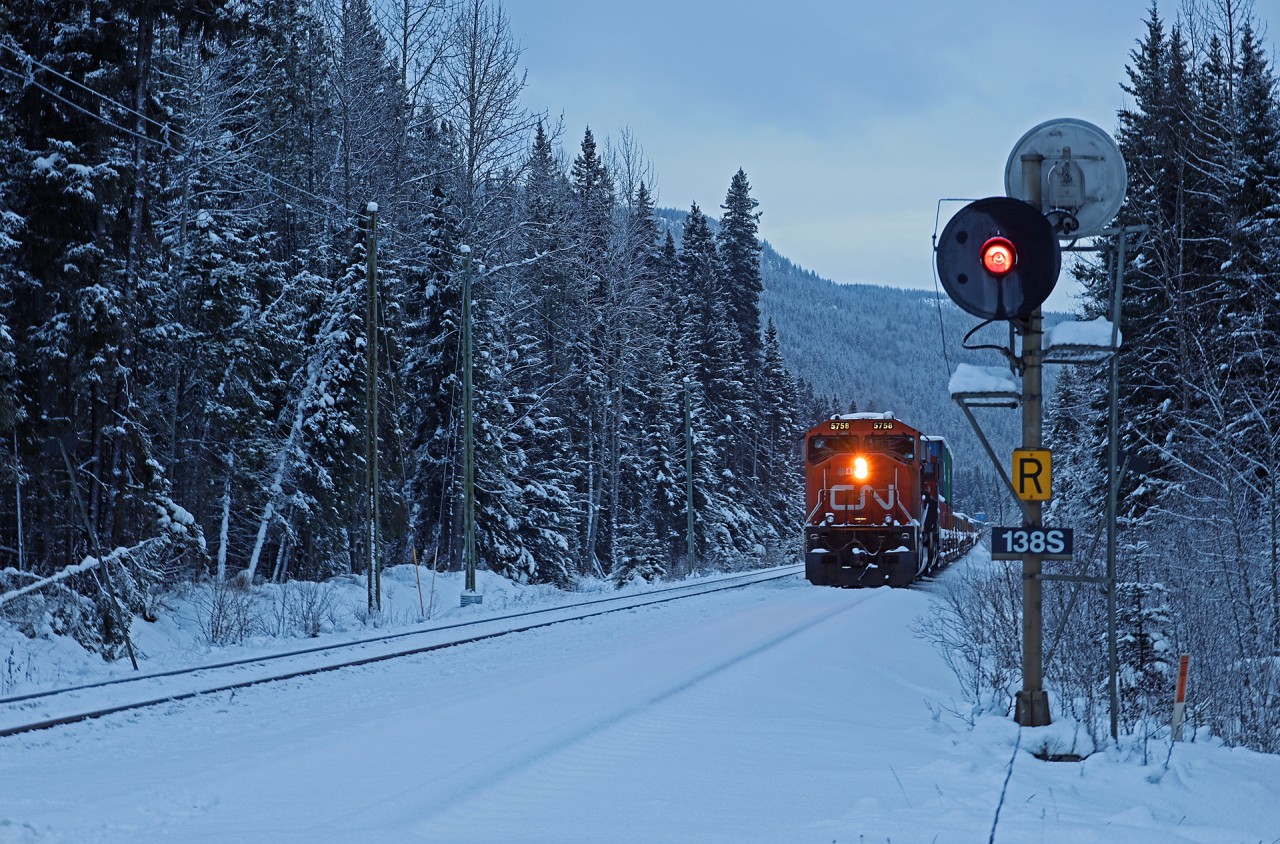 Due to the washouts on the Ashcroft and Yale Subs, Q 11751 16 has been staged just west of Jasper for a few days.  As a snowy day in the Rocky Mountains draws to a close, a new crew has just boarded and prepares to head westwards up Yellowhead Pass.