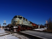 CP 251 is passing a crossing at MP 117 of CP's Sherbrooke Sub with a stellar lashup of CP 7022, KCS 4820 and CP 8107.