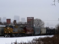 CN 305 passed parked counterpart CN 306 as it heads west in the snow with ex-CREX CN 3948 leading. CN 3948 is the ex-CREX 1428.