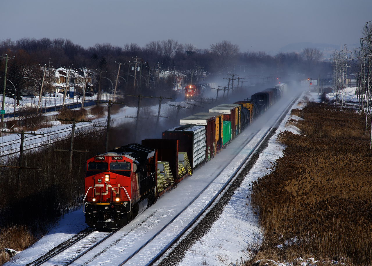 CN 305 is racing west, with CP F95 not far behind on the parallel CP Vaudreuil Sub.