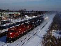 After switching the Coca-Cola plant in Lachine, CP F95 is heading to Baie-D'Urfé with CP 4513, CP 3100 and nine cars. CN 305 is barely visible at right, heading west on the parallell CN Kingston Sub.