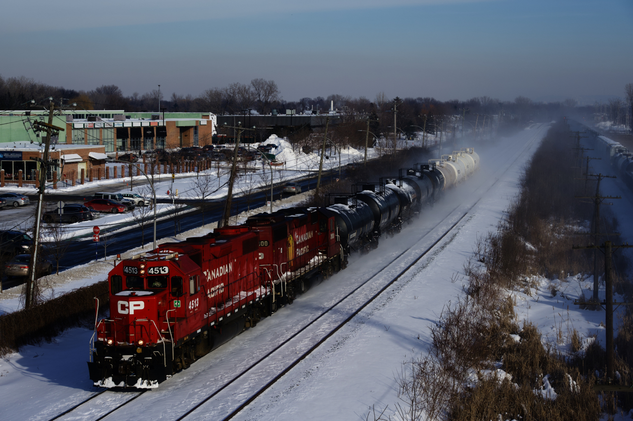 After switching the Coca-Cola plant in Lachine, CP F95 is heading to Baie-D'Urfé with CP 4513, CP 3100 and nine cars. CN 305 is barely visible at right, heading west on the parallell CN Kingston Sub.