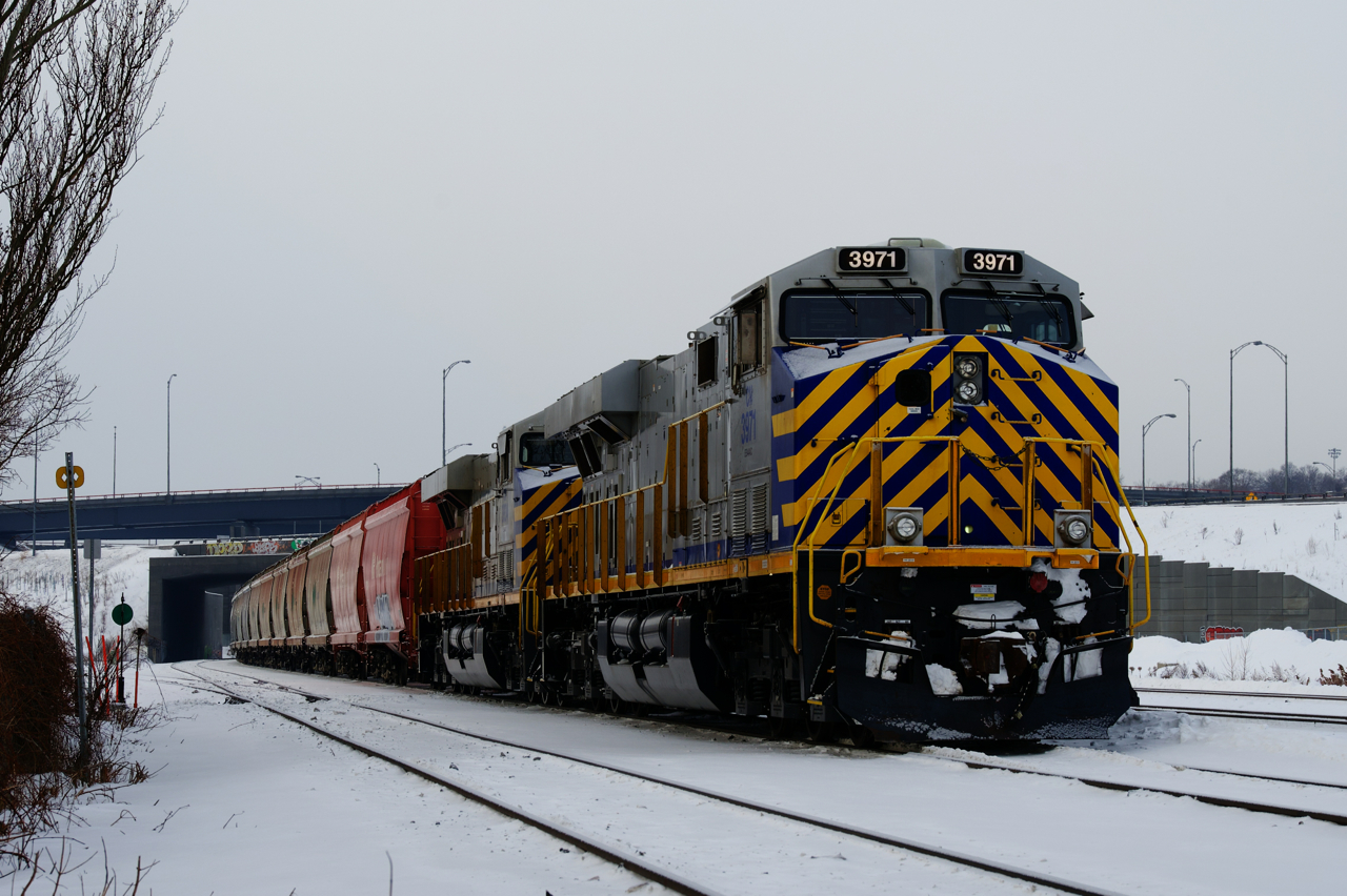 A pair of ex-CREX units (CN 3971 & CN 3934) are arranged elephant style on a loaded potash train that is parked near MP 4 of CN's Montreal Sub. On the tail end is a third ex-CREX unit (CN 3986). Both the leader and the tail end unit had been on lease to CN a few years back.