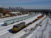 CN 305 has an ex-CREX leader as it passes a string of fresh CN grain cars that are parked on Track 29 of the Montreal Sub.