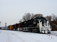 A small bit of flurries are falling as CN 324 passes MP 3 of CN's Montreal Sub with the Illinois Central heritage unit leading and CN 2955 trailing. After serving as the rear DPU unit on a stack train, CN 3008's nose is quite snow-covered.