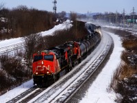 CN 369 has CN 3072, CN 2840 and 129 cars at it heads west through Beaconsfield on a frigid afternoon. 