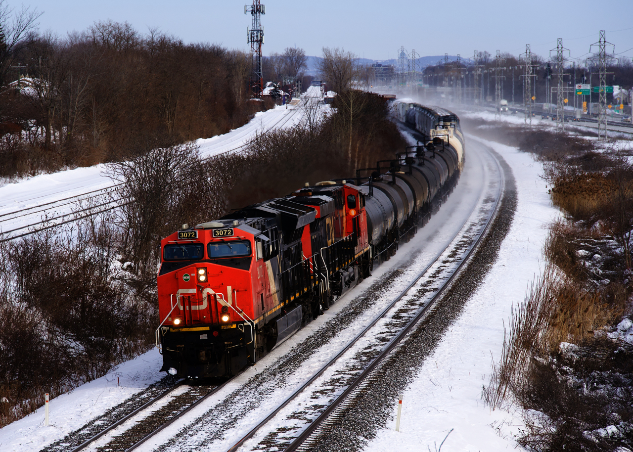 CN 369 has CN 3072, CN 2840 and 129 cars at it heads west through Beaconsfield on a frigid afternoon.