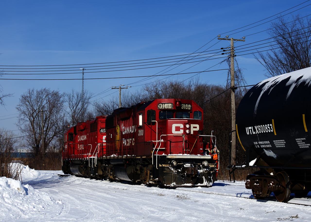 After lifting four empties and spotting two loads at Coca-Cola, CP F95's power (CP 3100 & CP 4513) is coupling back to the rest of its train. It will back up to the main line and then head west.