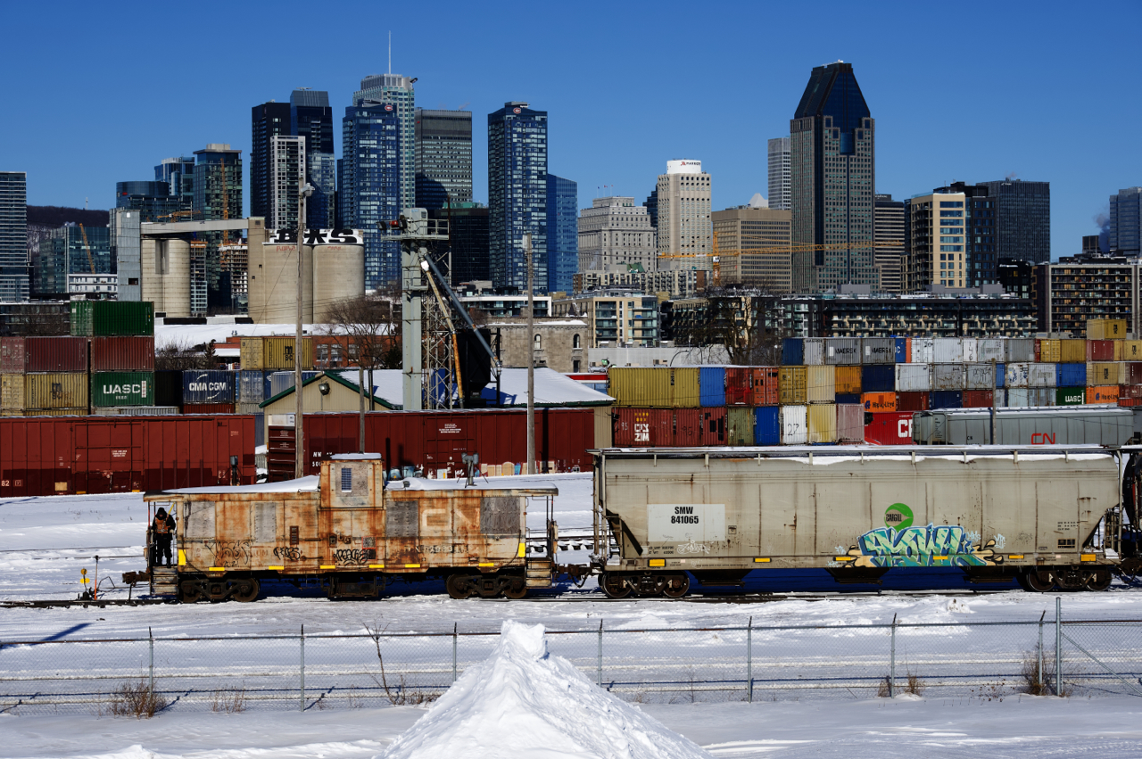 A crewmember is riding the Pointe St-Charles Switchers shoving platform as the train enters the yard.