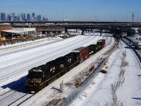 CN 529 has a pair of ES44DC's (NS 7715 & NS 7712) and a pint-sized train as it passes the skyline of downtown Montreal. It would clock in at 32 axles and 34 mph through the nearby hot box detector.