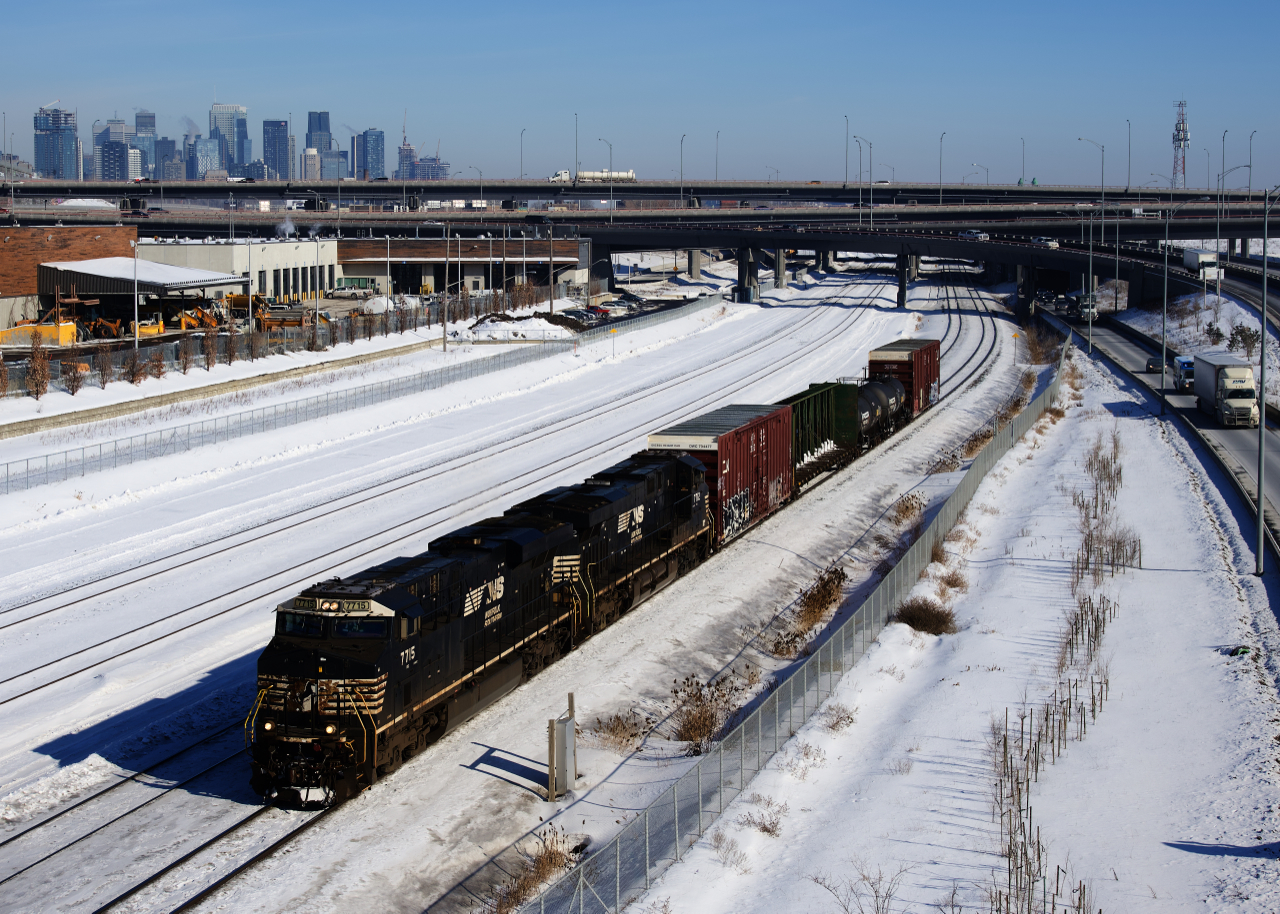 CN 529 has a pair of ES44DC's (NS 7715 & NS 7712) and a pint-sized train as it passes the skyline of downtown Montreal. It would clock in at 32 axles and 34 mph through the nearby hot box detector.