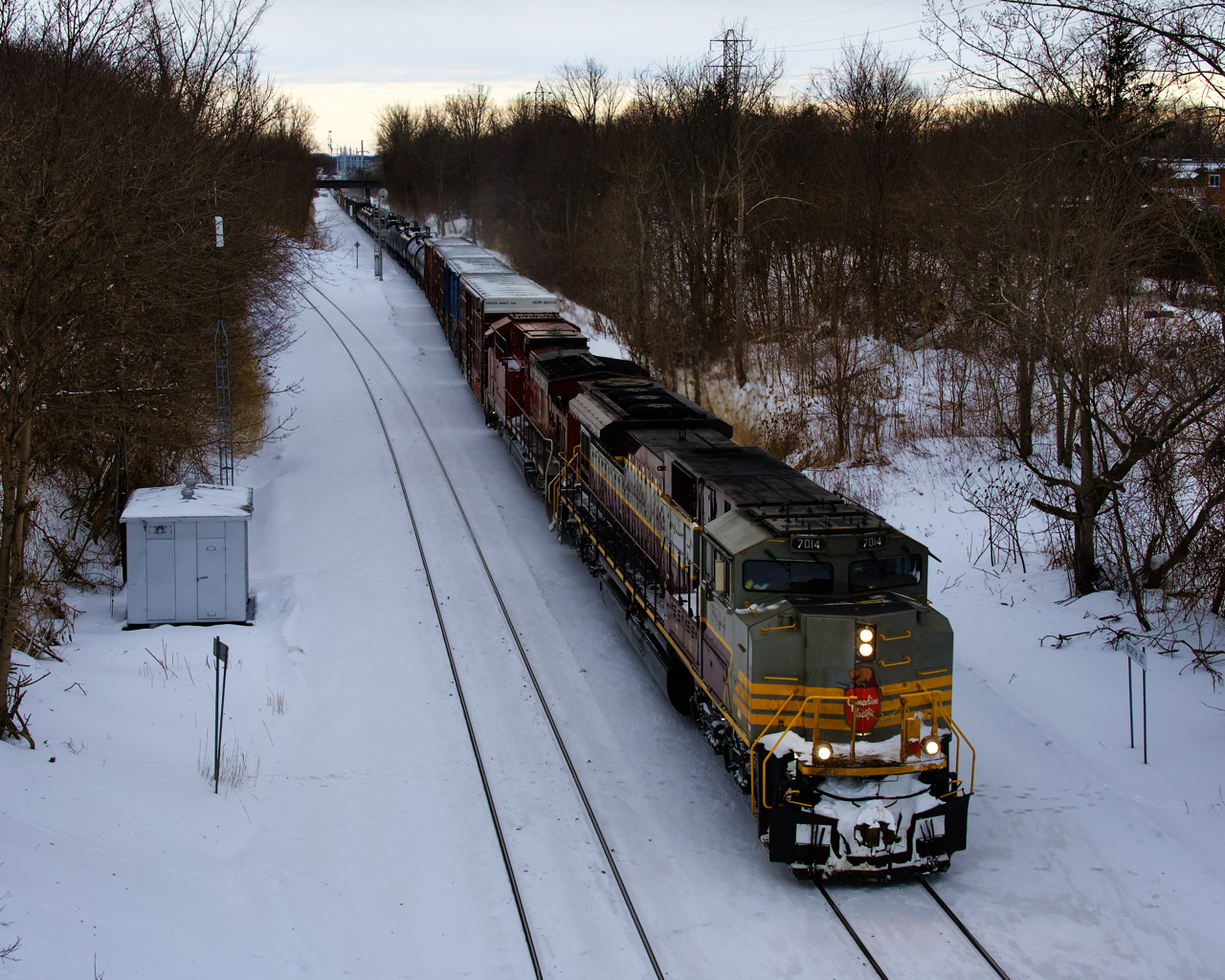 Heritage unit CP 7014 and CP 8023 lead a 69-car CP 251 past North Jct on a cold afternoon.