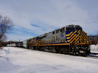 CN 322 has a pair of ex-CREX units arranged elephant style (CN 3948 & CN 3939) as it passes through the St-Henri neighbourhood of Montreal with 112 cars and CN 2802 mid-train.