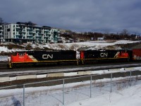 A pair of EMDs (CN 5610 & CN 8820) lead CN X309 westwards.