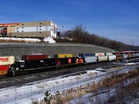 Heritage unit CN 3008 and CN 100 unit CN 3884 are the power on empty grain train CN 875, which has just departed Turcot Ouest after getting recrewed. Behind it CN 120 heads east.