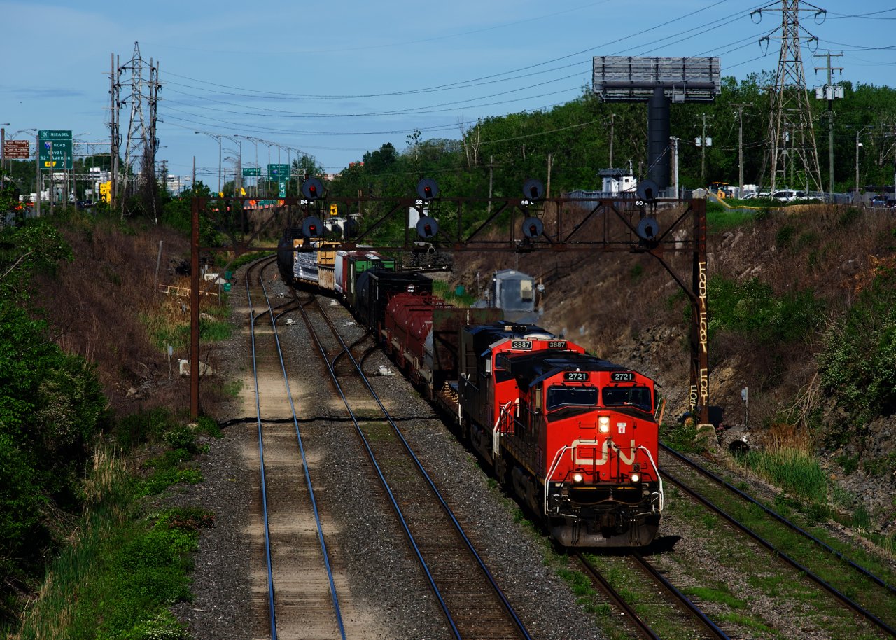 CN 310 has IC 2721 & CN 3887 for power as it crosses over from the North Track to the Freight Track. A bit further ahead it will back up to the Transfer Track to set off cars bound for Joffre. CN 400 will pick them up later that day.