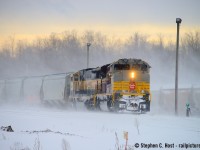 Hot enough for you? Summer hasn't even started and we're nearly at 30 degrees in Ontario as I post this so I saved this for a hot day to help cool you off. Pictured after a snowstorm, the sun is glowing orange through a filter of blowing snow carried by a cold and stiff January wind. Blowing snow is obscuring views of the motive power which sent a gaggle of folks trackside, this CP Heritage - "executive" mac scheme are working Guelph Junction, with the crew begrudgingly performing a set off of nearly 40 cars. After calling the RTC to belabour the difficult conditions they were encountering, the RTC forced them to proceed with their work but not after they pleaded for a maintainer to be sent to help as it can be very difficult for one person to dig out switches after a snow storm, let alone in winds this stiff and snow that viscous. I'd like to point out to folks who dream of working for the Railway that this is what I consider the ultimate "are you sure you do?" photo:  behind that train is a man (or woman depending on the crew) trudging through all that, broom in hand, digging switches, alone, climbing up and down setting handbrakes, toiling away for the company's benefit, with only a locomotive cab to keep them warm when it's all done. Bless the folks that do; often unsung heroes; normally on days like this you do your work and move on and no one notices, probably not even your boss, but on this day there was an audience for the day's railway theatre, and we noticed. The maintainer never did come and it took over two hours. Good job.