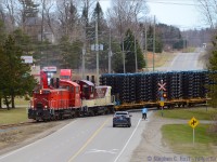 Multiple modes of transportation meet in Putnam Ontario as OSR re-routed Formet Industries frames from St. Thomas are brought to CN at Beachville due to a major rebuild of the Talbot sub. Unusual for OSR to handle Frame Traffic, this hadn't been seen on the St. Thomas Subdivision since 2009 when CP last hauled frames for the GM plant in Oshawa <a href=http://www.railpictures.ca/?attachment_id=47959 target=_blank> (example pic of St. Thomas sub action under CP)</a>. The re-routes were necessary as CN lifted the Barwick St. Bridge track too high so frames could no longer clear the L&PS built structure, and GM needs frames daily to produce cars, so OSR was called in to help for a few days while CN fixed their major mistake.