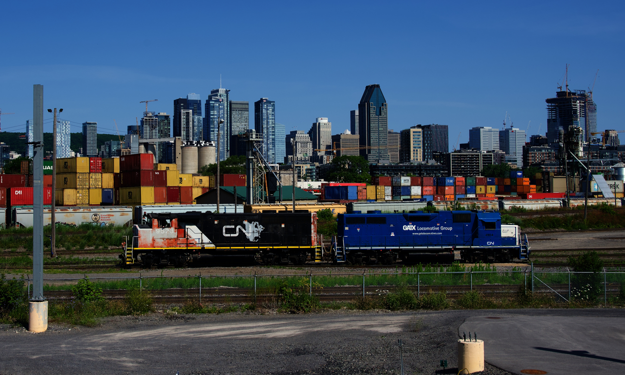 After dropping off grain cars in the Pointe St-Charles yard, CN 9523 & ex-GMTX CN 4904 are heading west light power.